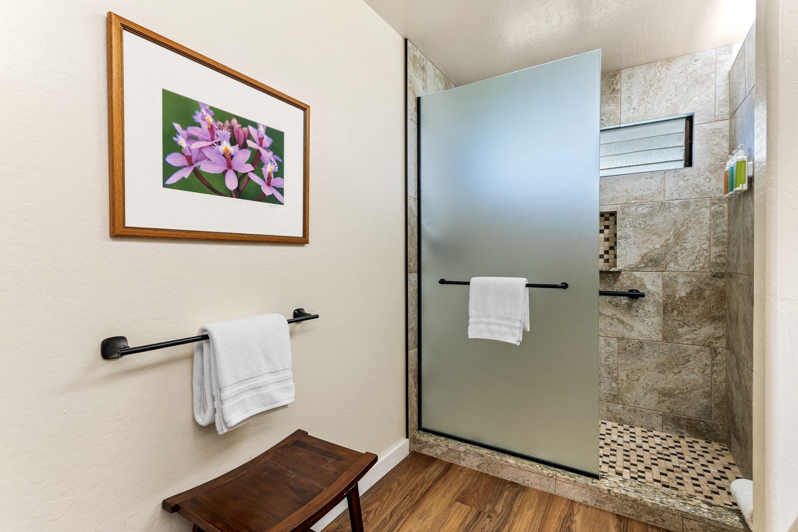 Kailua Kona Vacation Rentals, Kanaloa at Kona 1606 - Stone-tiled shower behind glass, a framed bloom for company.