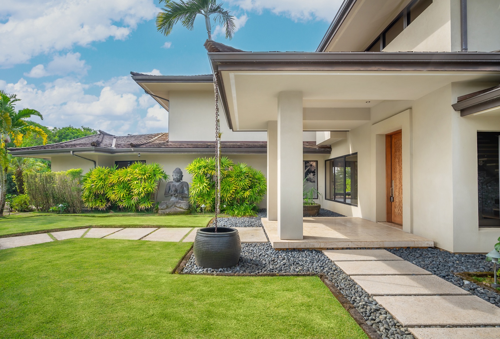 Princeville Vacation Rentals, Hanalei Plantation Villa - Pathway to the main entrance, featuring well-maintained grounds and contemporary landscaping.