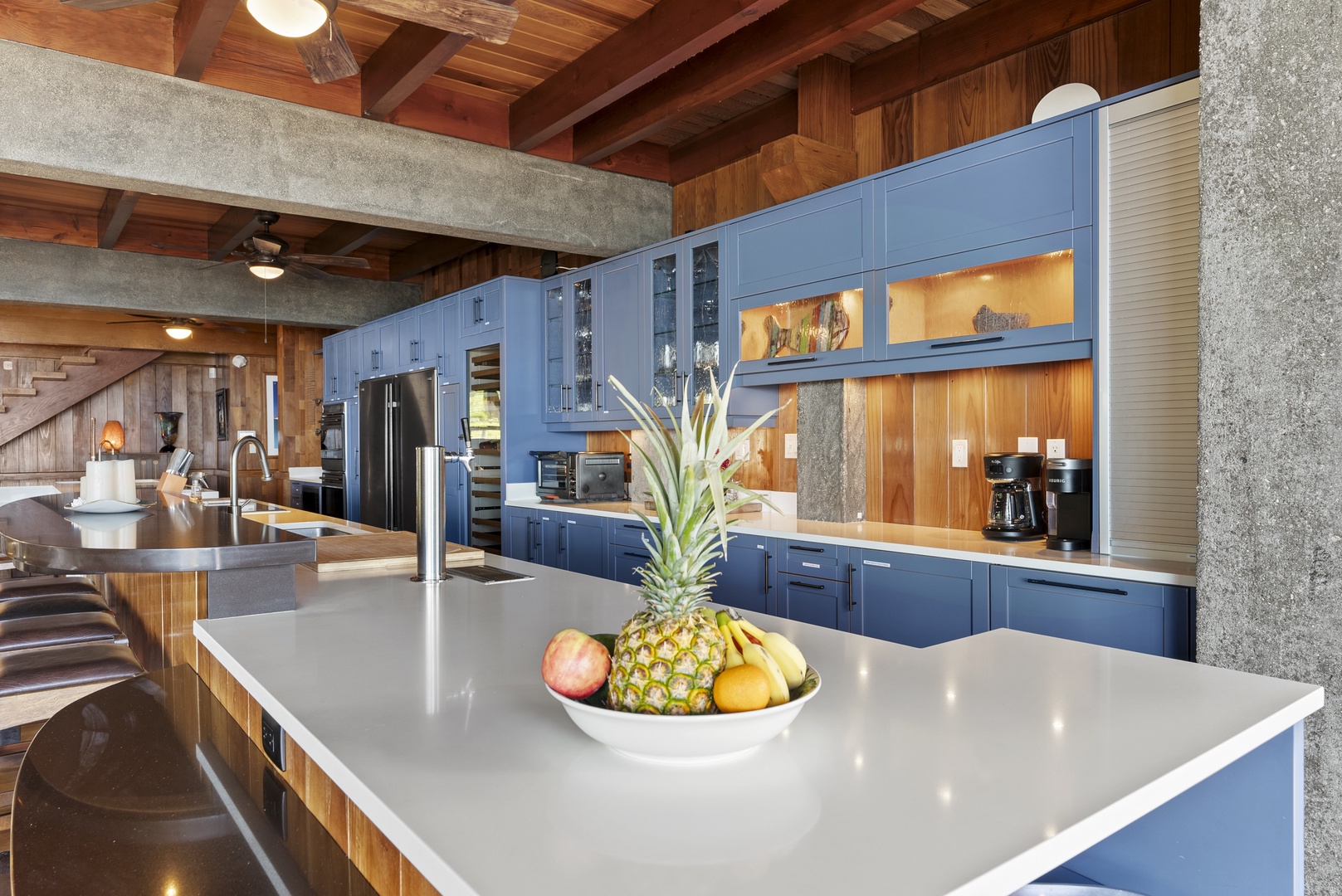 Haleiwa Vacation Rentals, Samurai House - Stunning gourmet kitchen with sleek blue cabinetry, island seating, and top appliances.