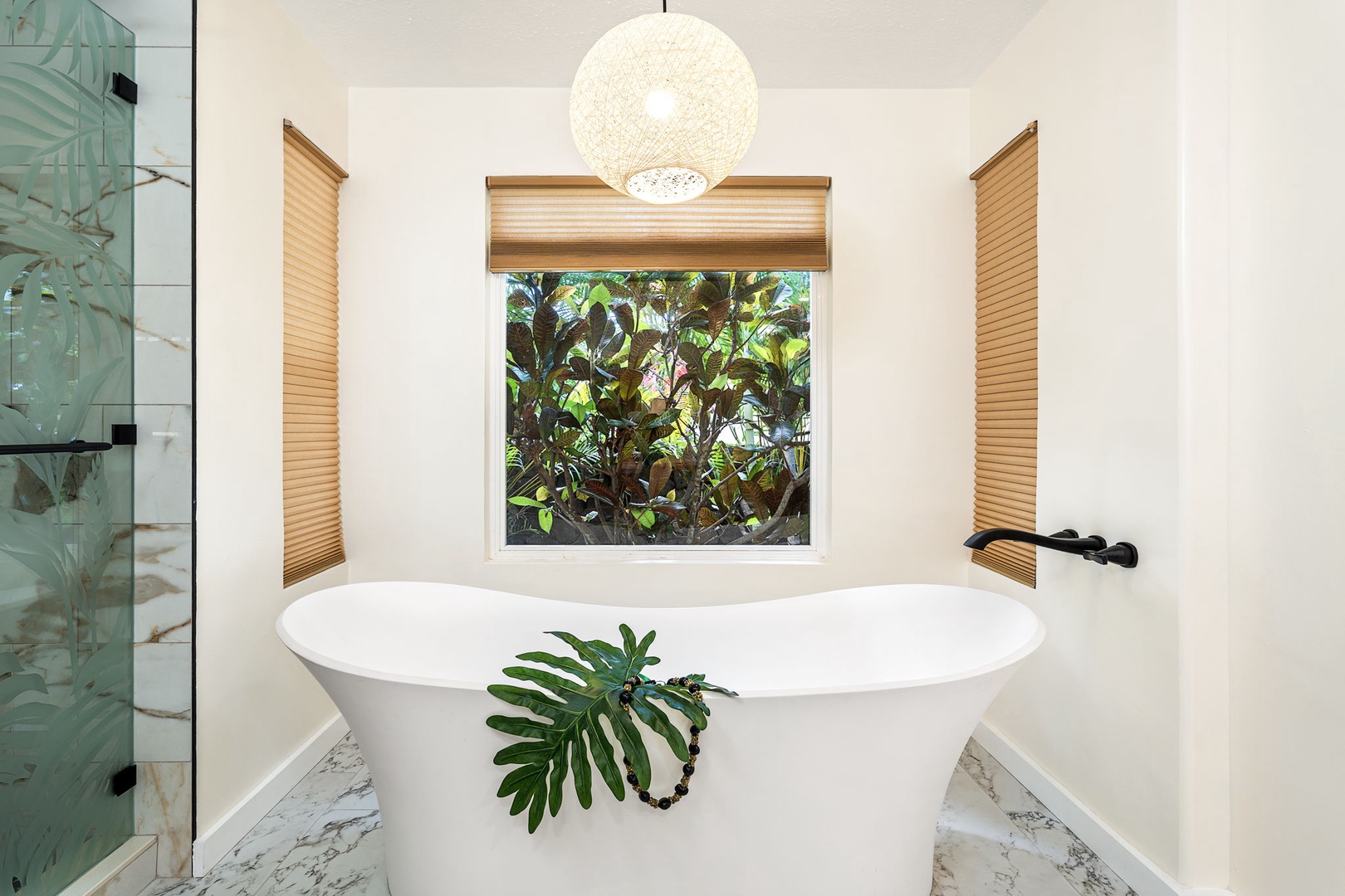 Kailua-Kona Vacation Rentals, Honu Hale - Slip into your luxurious soaking tub beneath the sculptural pendant light, where warm wood blinds frame lush garden views for the ultimate spa retreat.