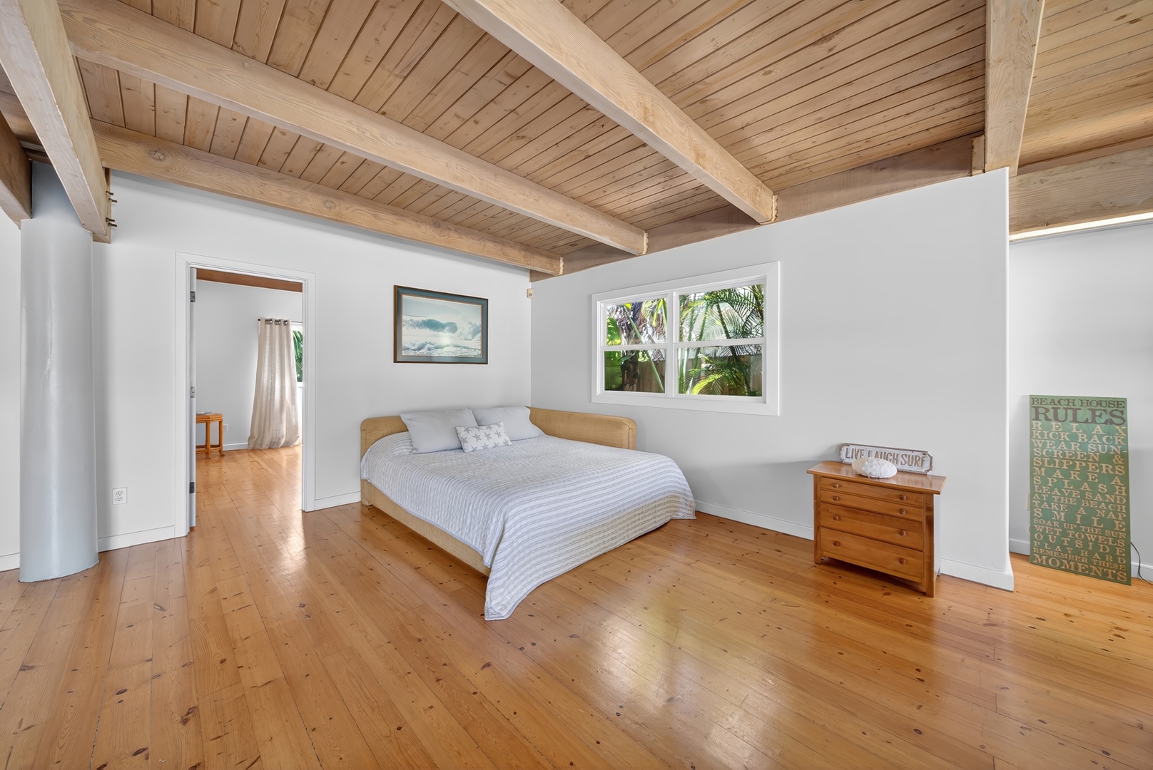 Haleiwa Vacation Rentals, Sunset Beach Hideaway - Recharge in the Pune'e in the downstairs living room with a California King bed, warm wood ceilings and garden surroundings.