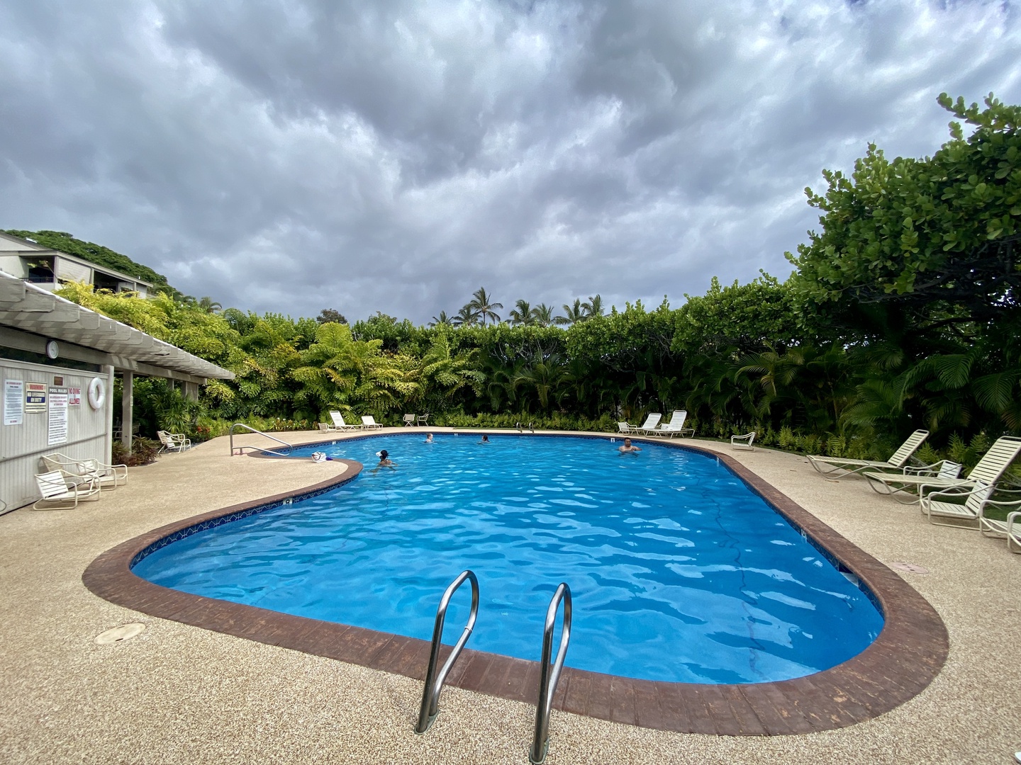 Kihei Vacation Rentals, Wailea Ekolu 1605 - A peaceful pool surrounded by lush greenery, perfect for a refreshing swim or a relaxing afternoon lounging by the water.