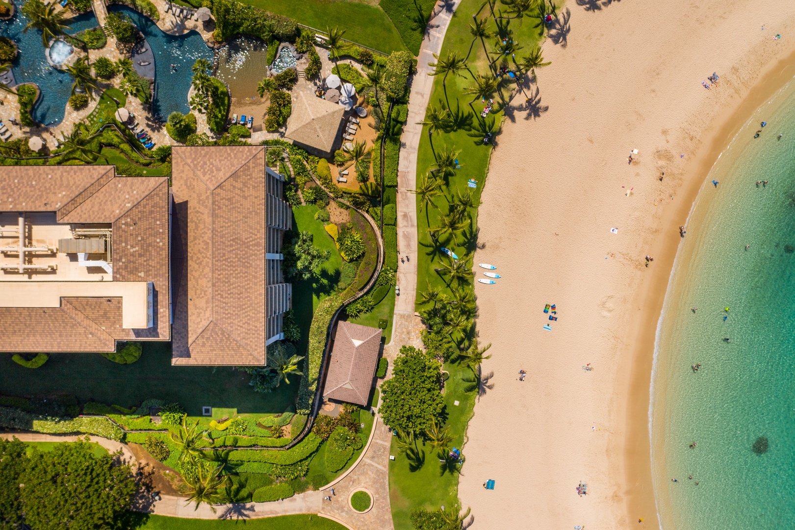 Sand wraps the buildings on two sides, the lagoons pulling in close.