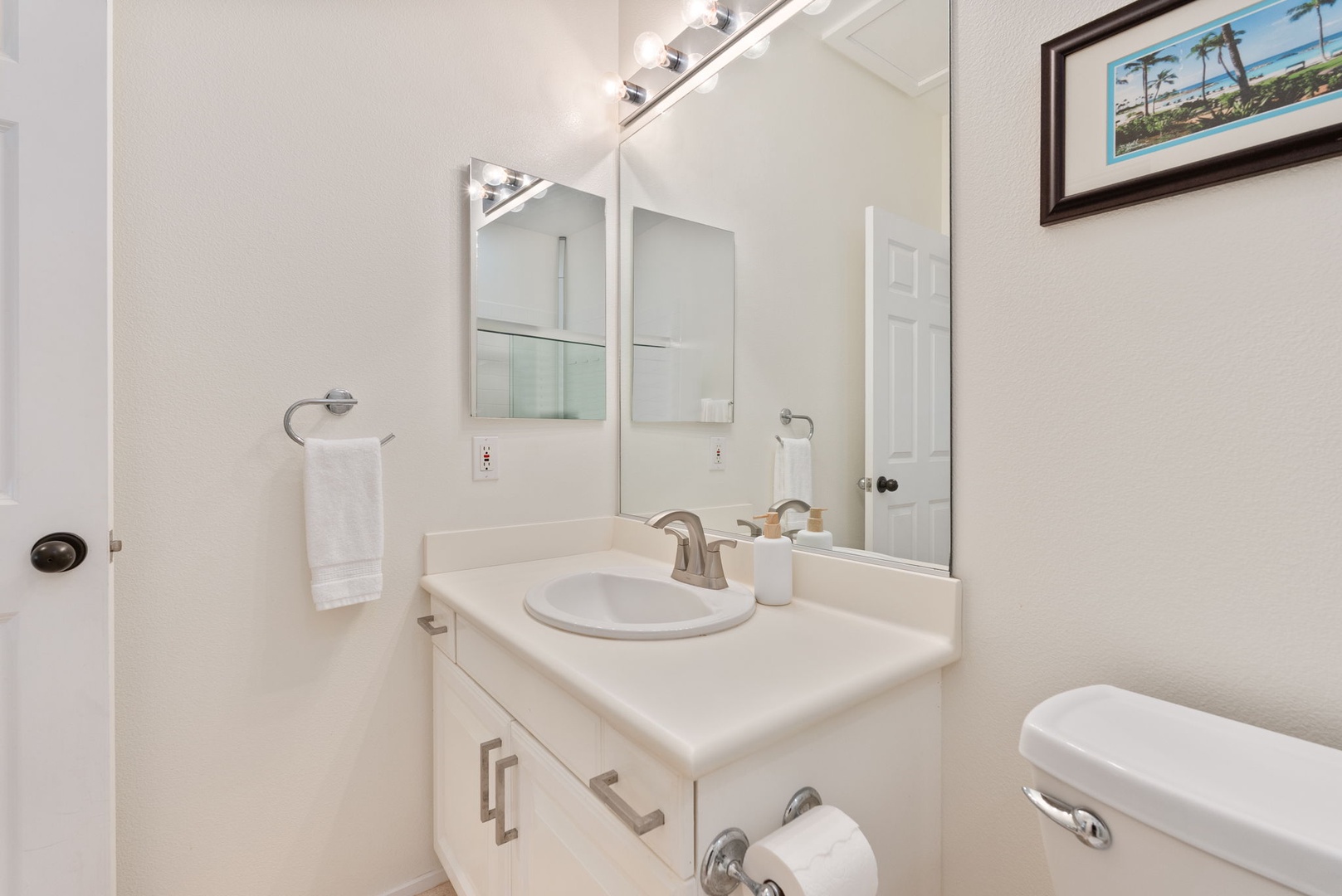 Kapolei Vacation Rentals, Coconut Plantation 1080-4 - Get ready without a line for the sink at the guest vanity and mirror.