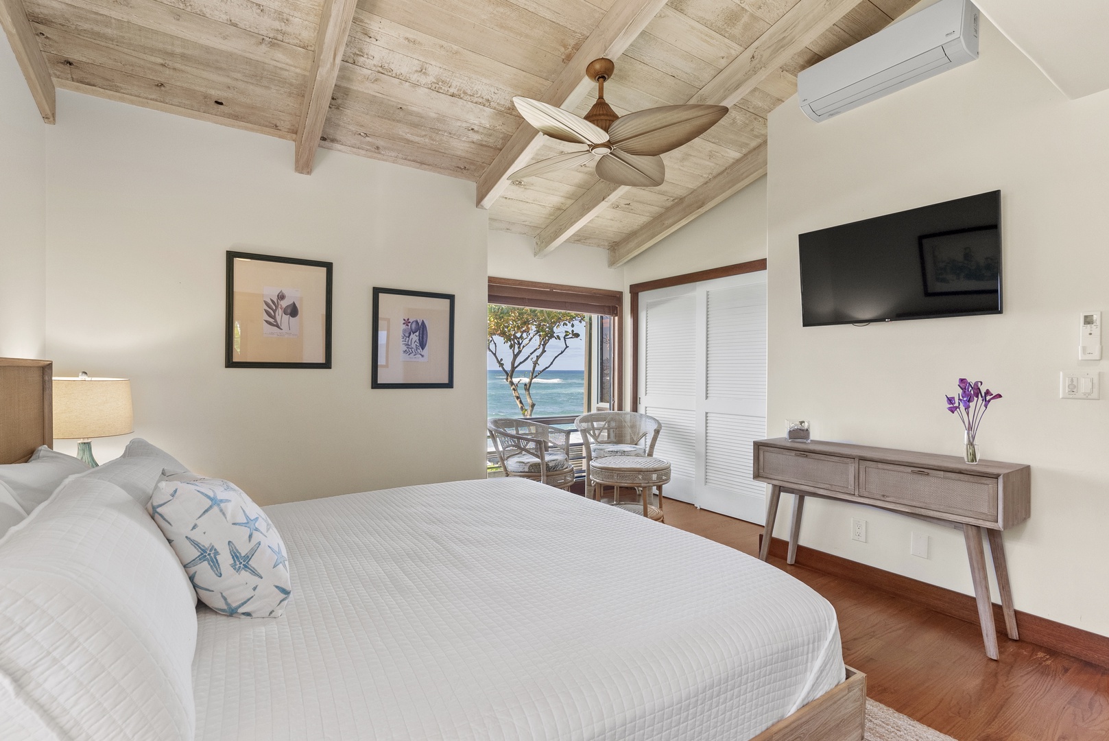 Haleiwa Vacation Rentals, Maluhia Beach House - Tranquil bedroom with a king-size bed, vaulted ceilings, and a cozy seating area.