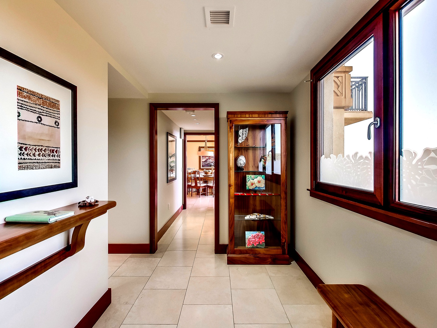 Kapolei Vacation Rentals, Ko Olina Beach Villas O1011 - Warm wood tones and framed artistry throughout the home.