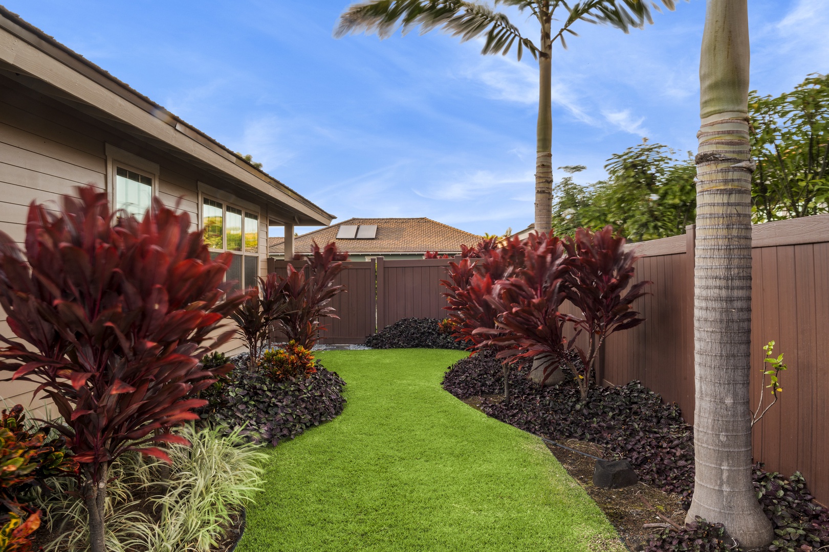 Kailua Kona Vacation Rentals, Kona Blue Vacations Holua Kai - Lush side yard at Kona Blue Holua Kai offers extra space to play, relax, or stretch out with a view.