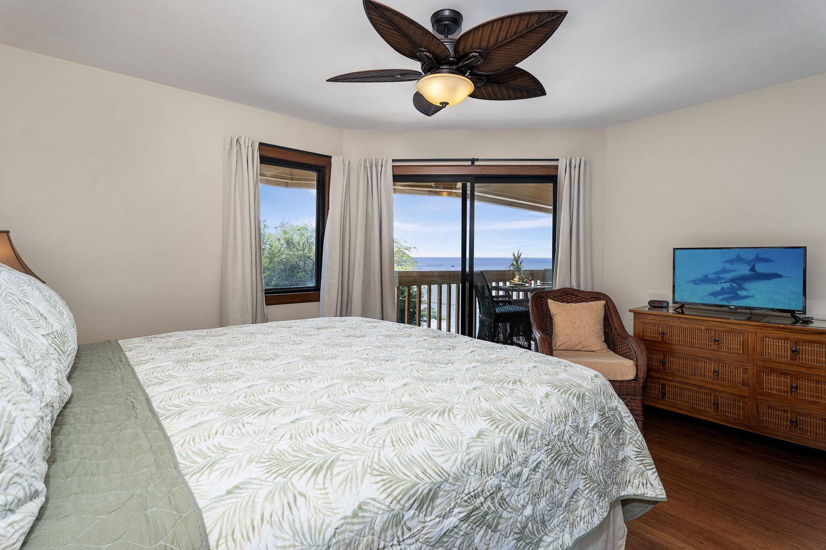 Kailua Kona Vacation Rentals, Royal Kahili 401A - Elegant bedroom featuring a king-sized bed, dresser, and windows with tropical views.