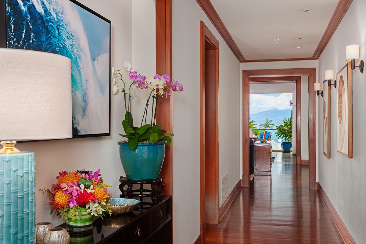 Kapalua Vacation Rentals, Ocean Dreams Premier Ocean Grand Residence 2203 at Montage Kapalua Bay* - Ocean Theme Artwork in Hallway with Richly Colored Wood Floors