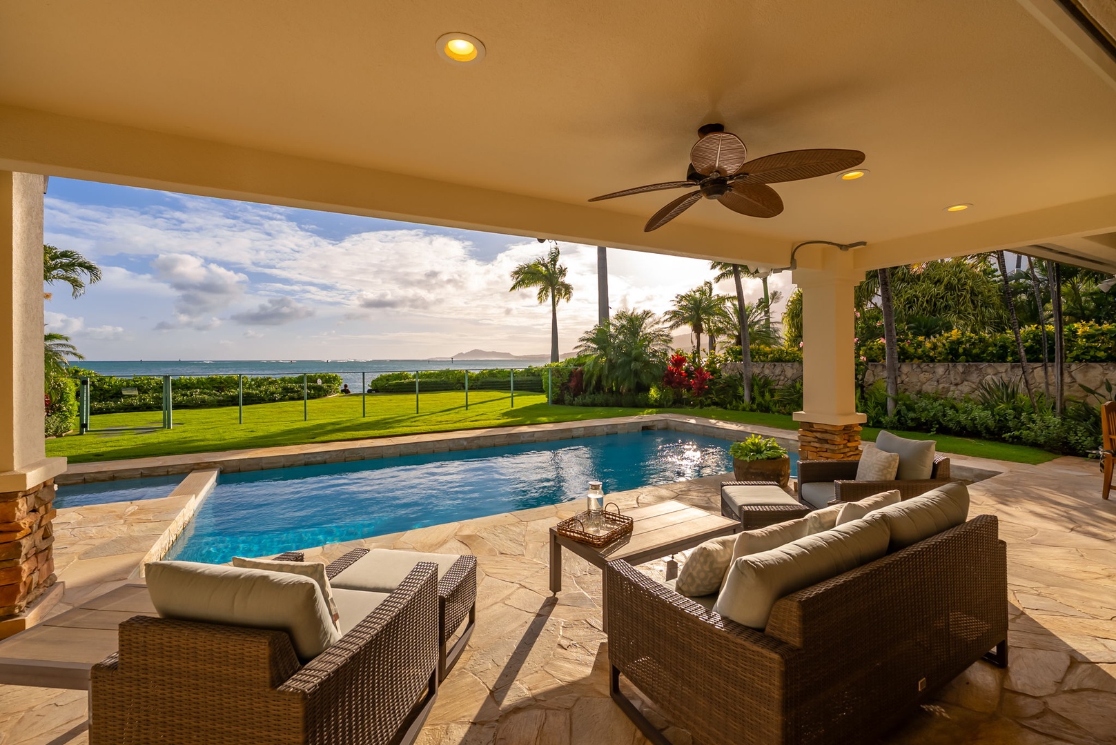 Honolulu Vacation Rentals, Maunalua Estate - The pool, lush lawn, and sparkling ocean create a seamless connection to the shoreline.