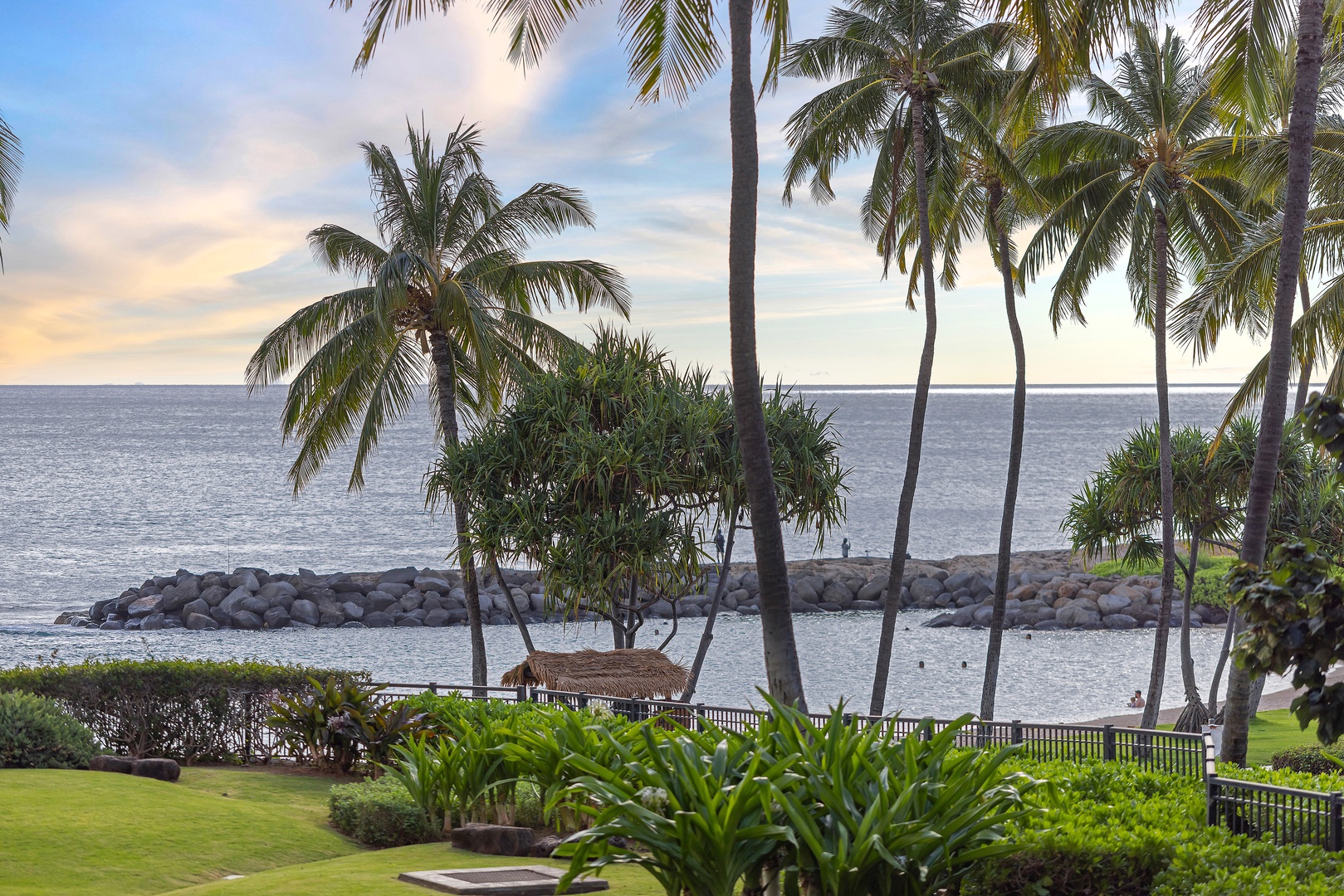 Oceanfront setting with swaying palms, a protected cove, and a peaceful gazebo pier—perfect for soaking in tropical island views.