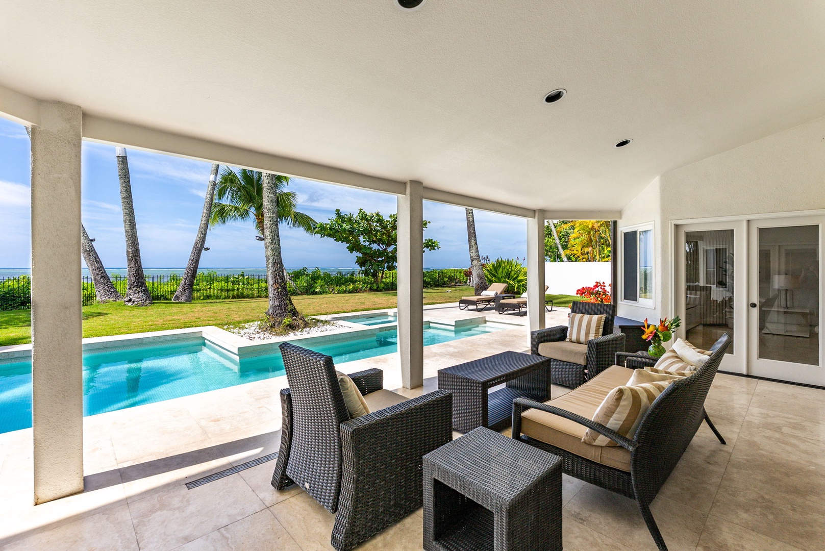 Honolulu Vacation Rentals, Paradise Beach Estate - Unwind poolside beneath a shaded lanai—perfect for morning coffee or evening cocktails with the sound of ocean waves nearby.
