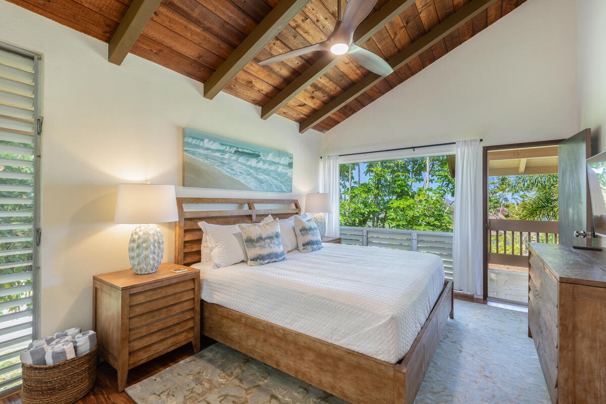 Princeville Vacation Rentals, Hale Ohana Ho'omaka - Primary bedroom with king bed, ensuite bath, and lanai access. Wake up to the breeze and sunshine.