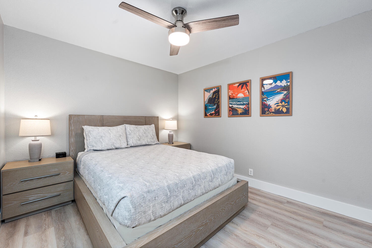 Kailua Kona Vacation Rentals, Hale Kai O'Kona #7 - Upstairs bedroom #1 featuring a queen bed and island-themed artwork.