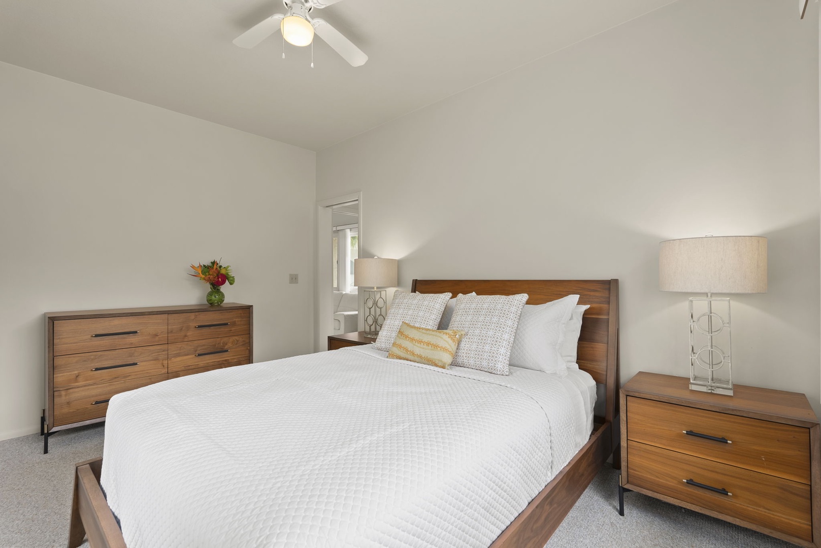 Honolulu Vacation Rentals, Paradise Beach Estate - Relax in this airy guest bedroom, complete with cozy bedding, warm wood accents, and soft lighting throughout.