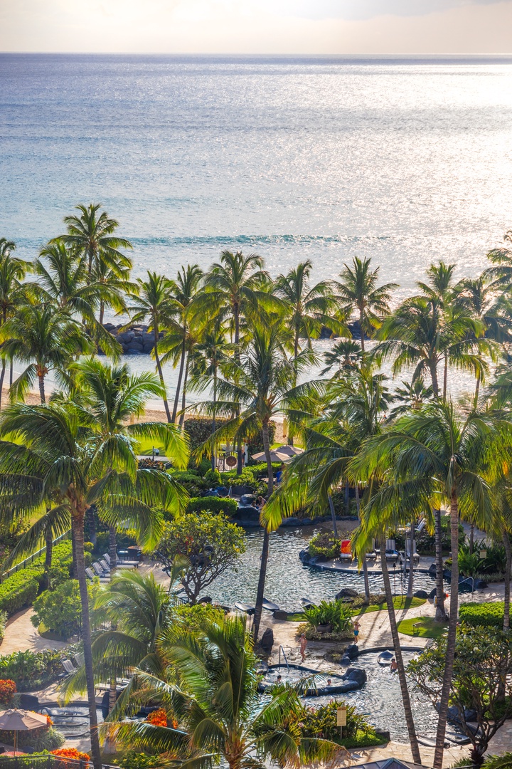 Kapolei Vacation Rentals, Ko Olina Beach Villas O1006 - Tropical paradise with sparkling ocean views, framed by lush palm trees and serene poolside lounging areas.