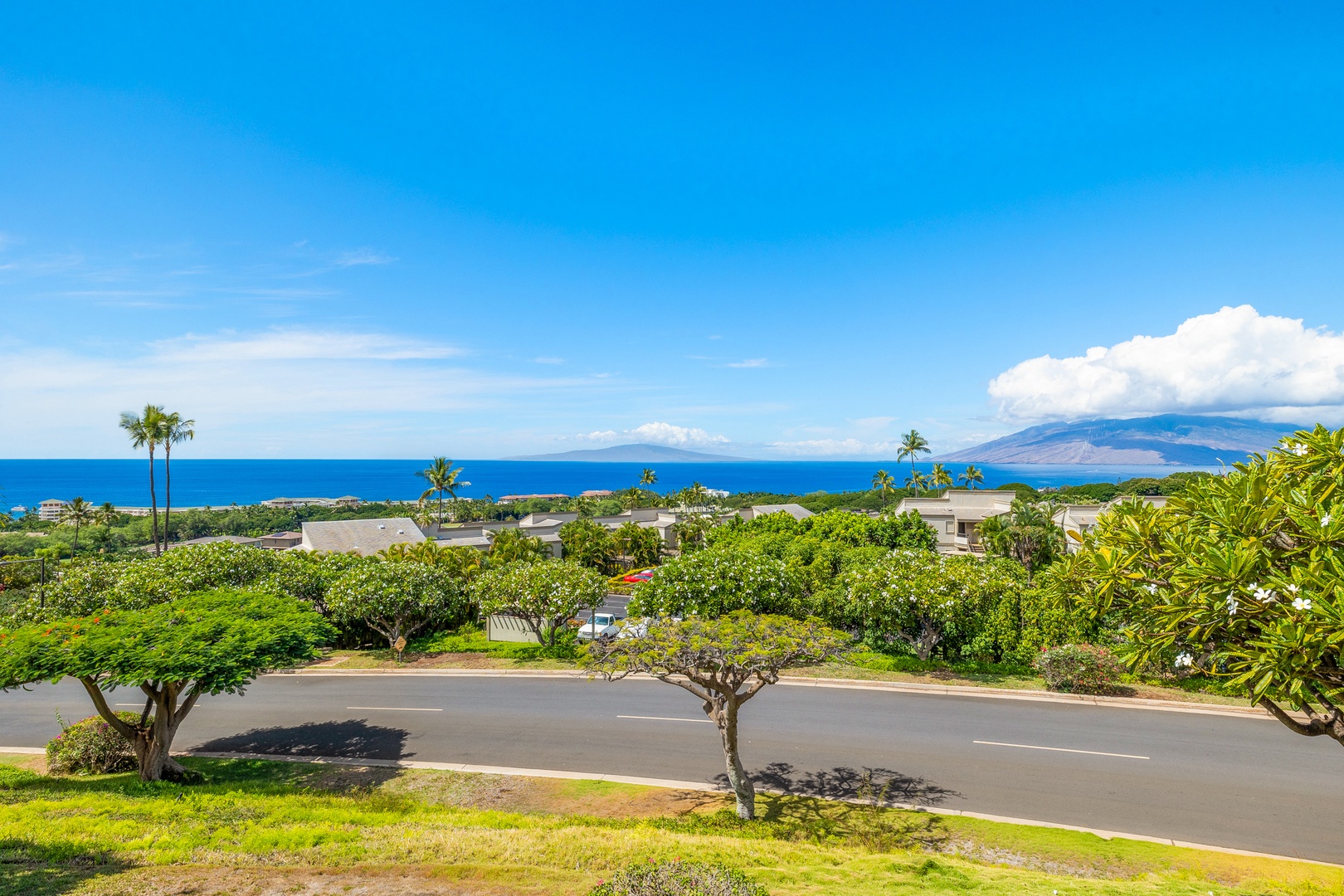 Kihei Vacation Rentals, Wailea Ekolu 1106 - Enjoy stunning ocean views from the lanai, with lush greenery and distant islands completing the serene scenery.