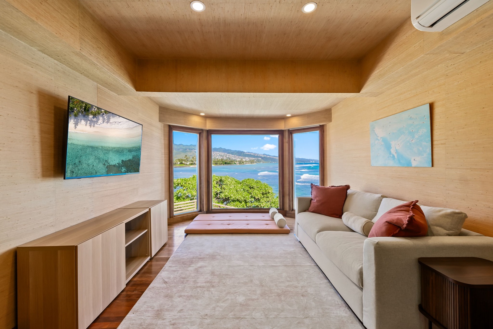 Honolulu Vacation Rentals, Black Point Ocean Villa - Serene bedroom with stunning ocean views, where warm wood tones and plush seating create the perfect retreat.