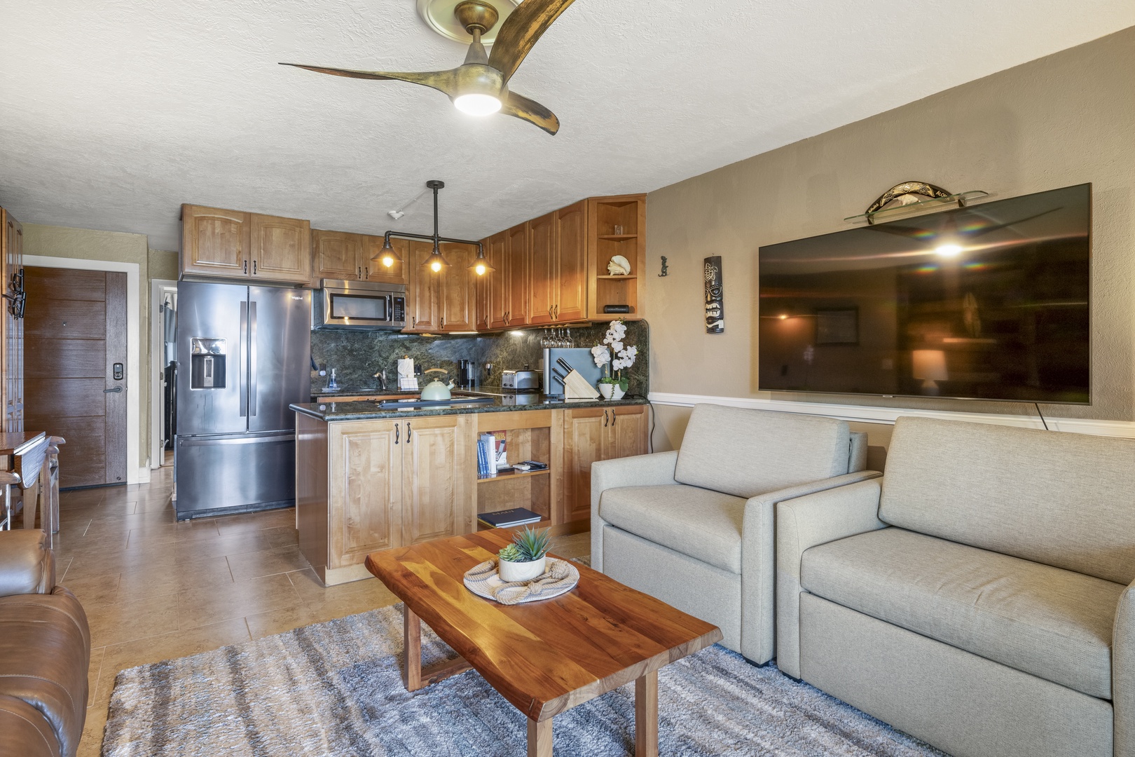 Lahaina Vacation Rentals, Polynesian Shores 114 - Sink into the sofa with the fan turning and the kitchen a step behind.