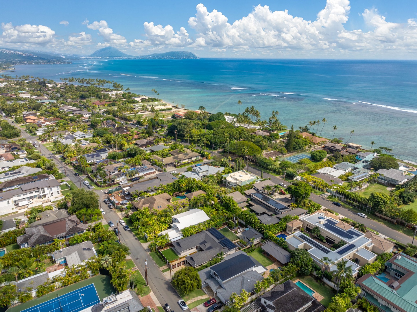 Honolulu Vacation Rentals, Kahala Zen - Stunning coastal aerial view showcasing the sparkling ocean and charming community.