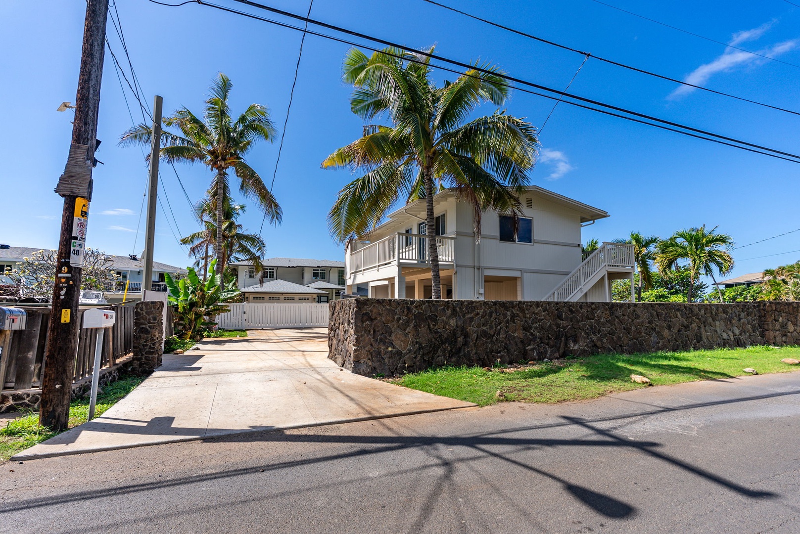 Waianae Vacation Rentals, Oceanfront Luxury Dream Estate - Paved driveway and side gate secure the home with style while blending into the upscale coastal aesthetic.