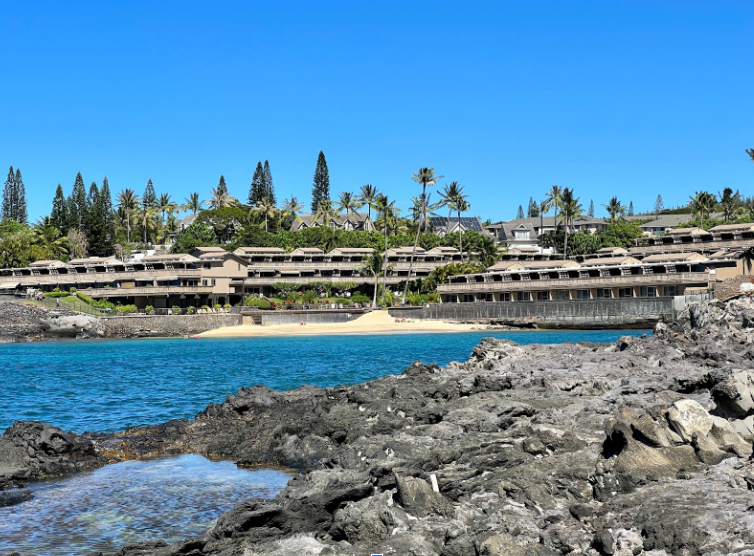 Lahaina Vacation Rentals, Kahana Sunset B4B - Take in the stunning view of this private beach nestled between rocky shores and lush greenery, perfect for a peaceful day by the water.