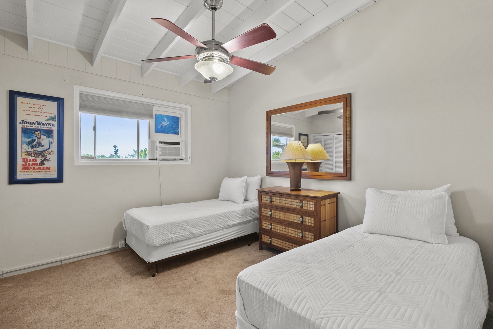 Haleiwa Vacation Rentals, North Shore Beachfront Retreat - Bedroom with two twin beds and a ceiling fan.