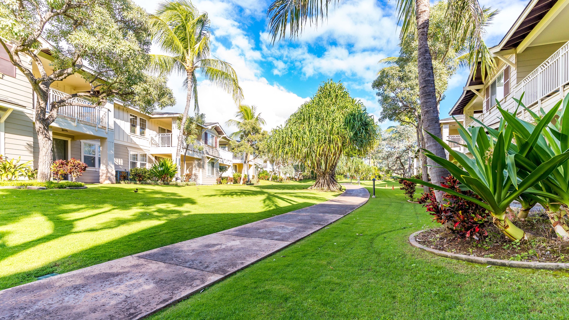 Kapolei Vacation Rentals, Ko Olina Kai 1083C - Paved walkways under swaying palm trees.