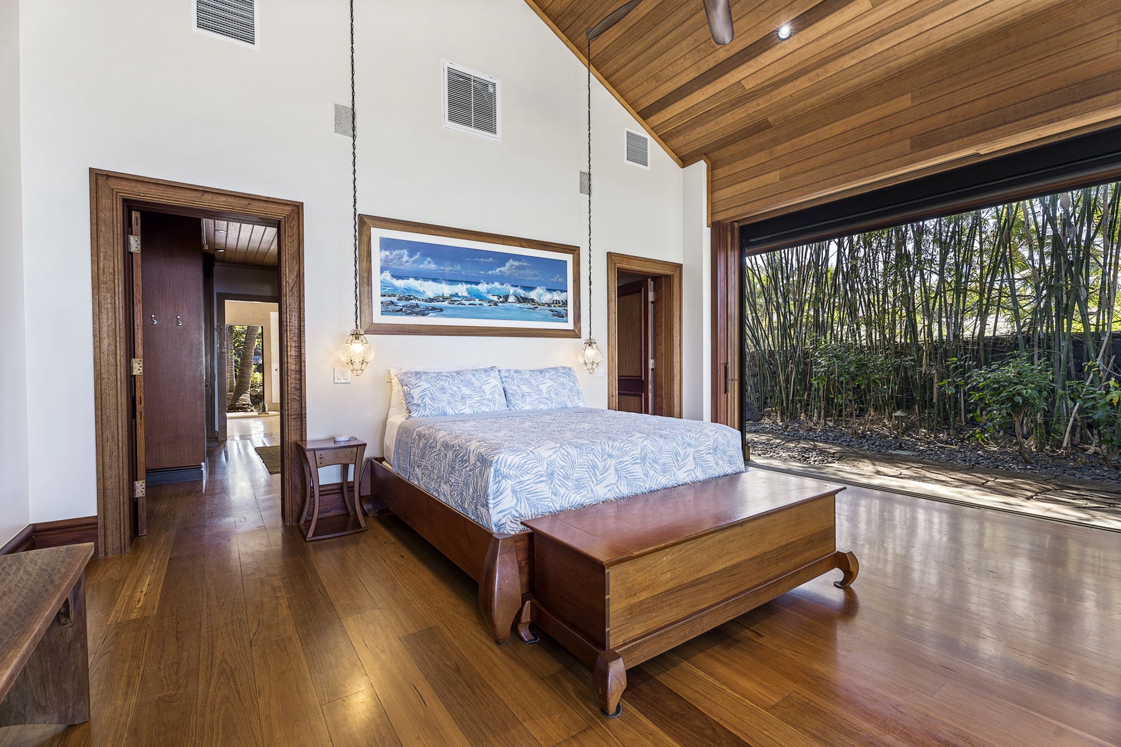 Kailua-Kona Vacation Rentals, Hahalua Bay Villa - Your primary bedroom sanctuary features rich hardwood floors, tropical garden views, and modern comfort beneath stunning wood ceilings.