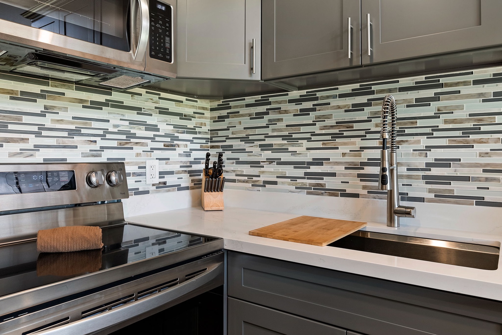 Kahuku Vacation Rentals, Kuilima Estates West #120 - Custom tile backsplash in the remodeled kitchen.