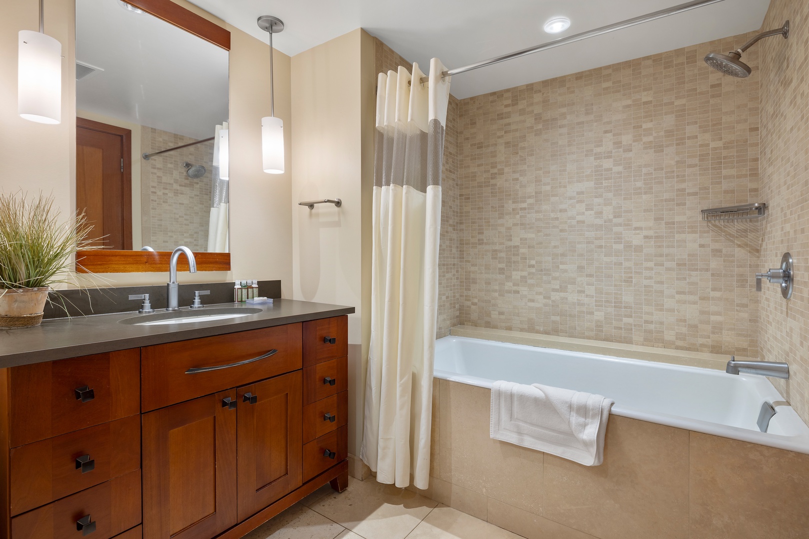 Kapolei Vacation Rentals, Ko Olina Beach Villas B403 - Unwind in your elegant bathroom featuring a deep soaking tub, rainfall shower, and warm wood vanity—perfect for refreshing after your adventures.