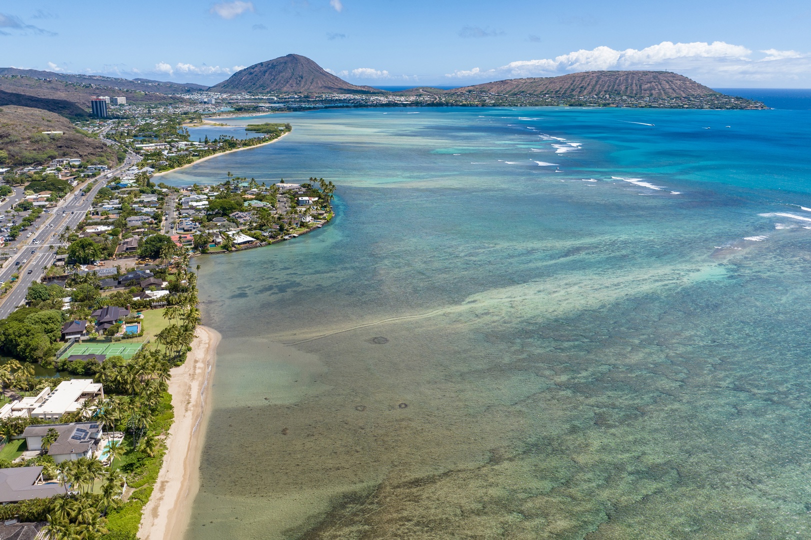 Honolulu Vacation Rentals, Moana Lani - Main House - Shallow turquoise reef water runs the length of the coast in this view from above.