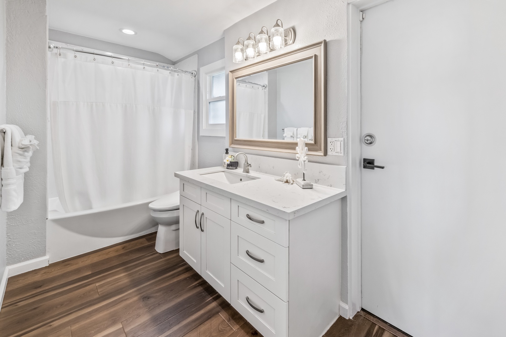 Honolulu Vacation Rentals, Nanea Kai Villa - Bright and clean shared bathroom with a spacious vanity and tub-shower combo.