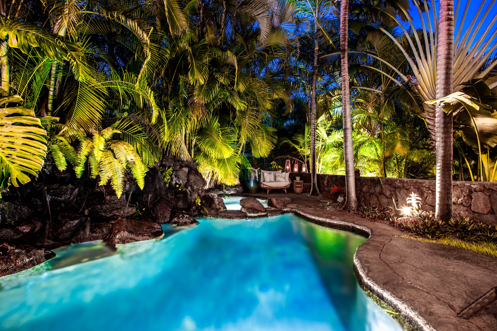 Honolulu Vacation Rentals, Pili Pono - Glowing lagoon-style pool nestled in lush tropical foliage.