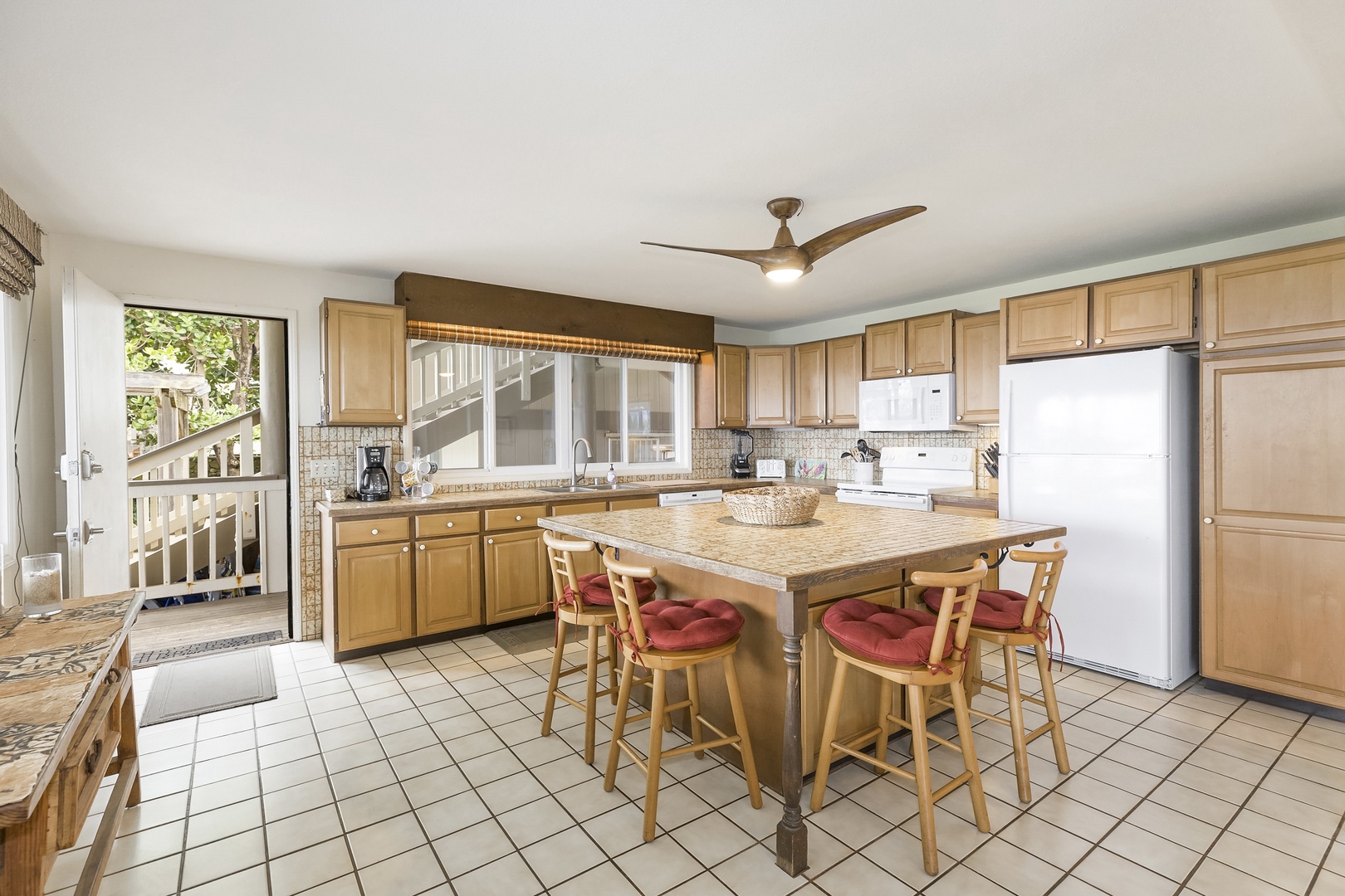 Haleiwa Vacation Rentals, Hale Kimo - The large kitchen island has seating for quick meals or visiting with the 'chef'