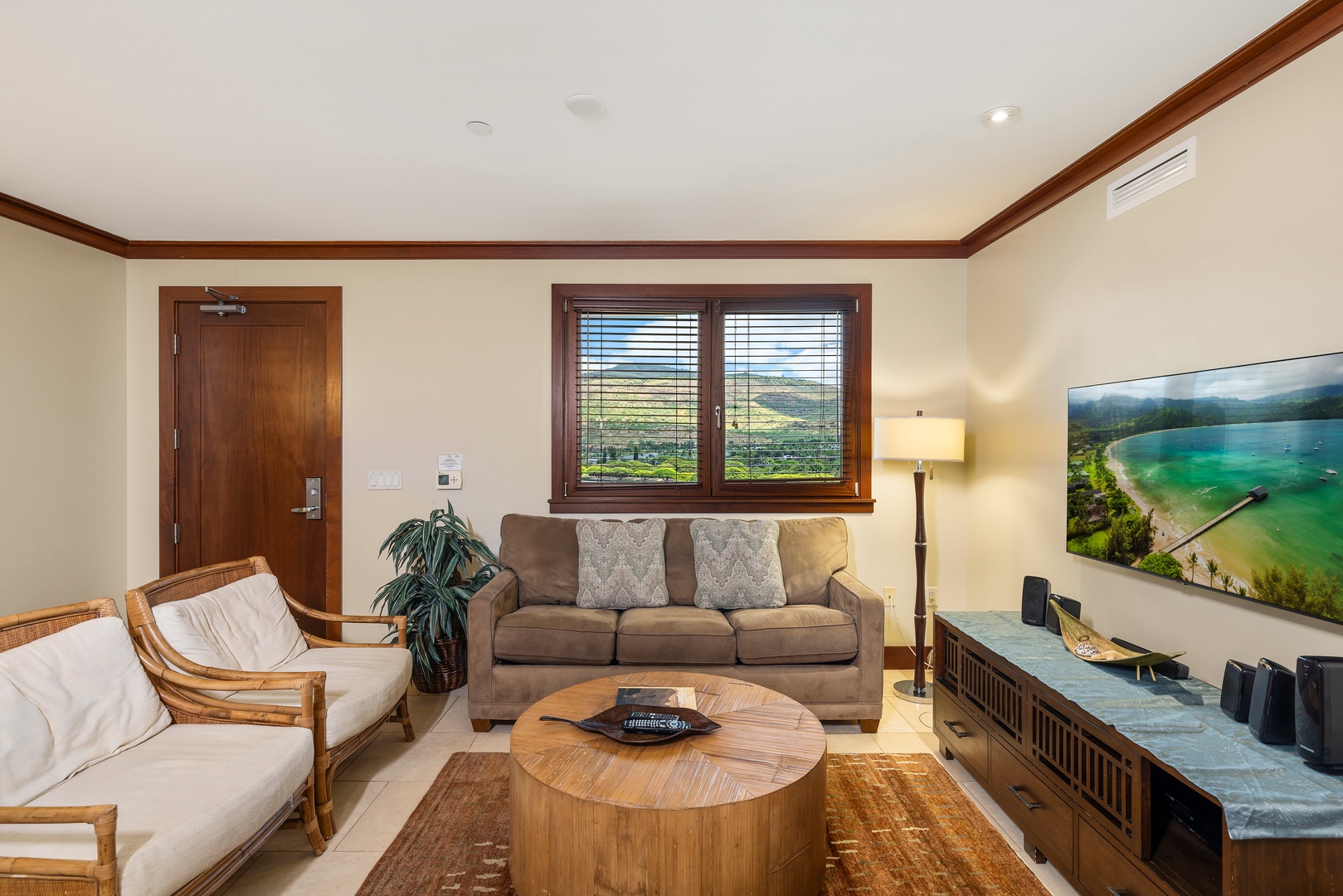 Kapolei Vacation Rentals, Ko Olina Beach Villas B901 - Unwind in your spacious living room with comfortable seating, warm wood accents, and beautiful countryside views through large windows.