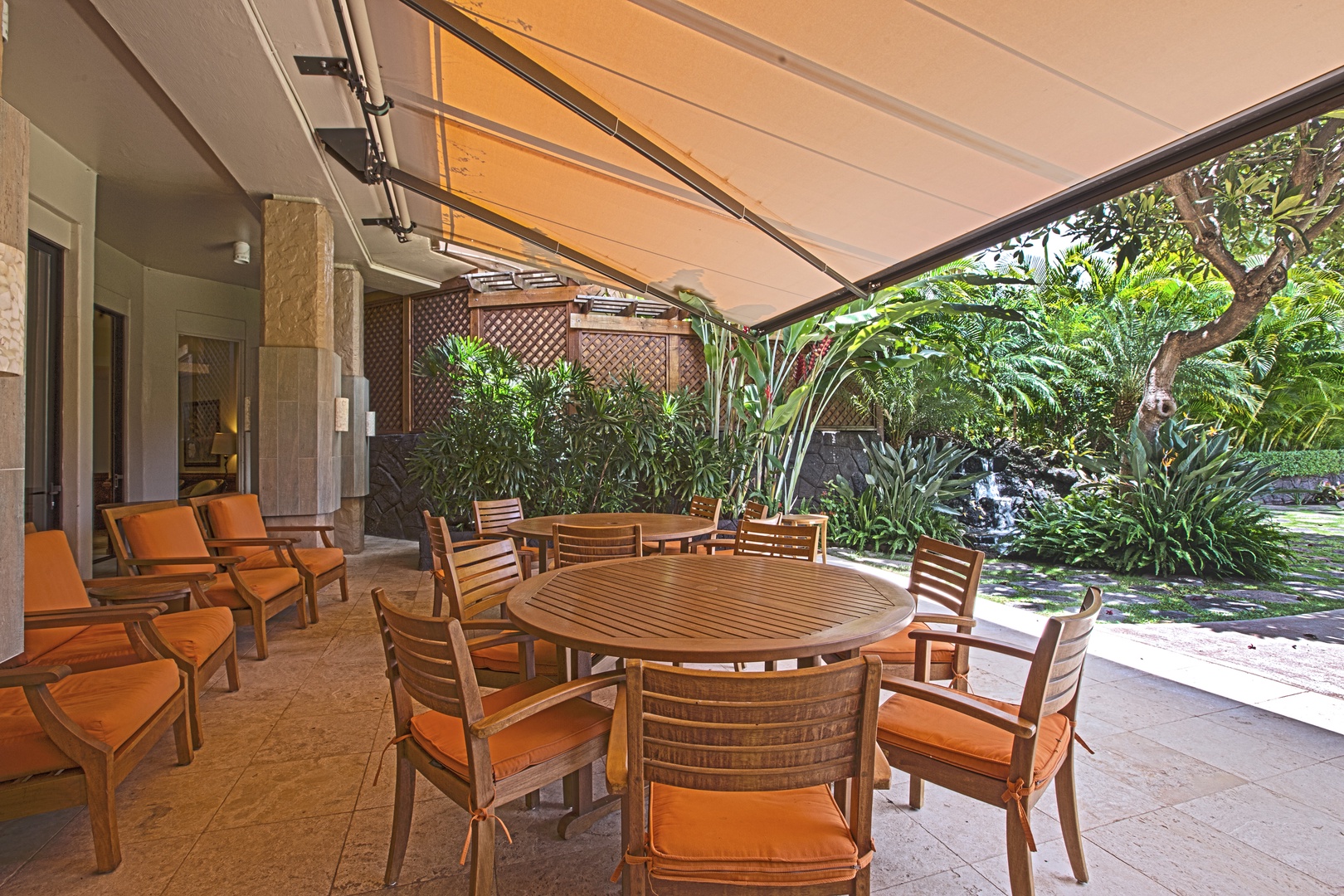 Lahaina Vacation Rentals, Maui Kaanapali Villas 292 - The shaded outdoor seating area offers a peaceful spot to enjoy meals or drinks while being surrounded by lush greenery—perfect for relaxing or socializing in comfort.