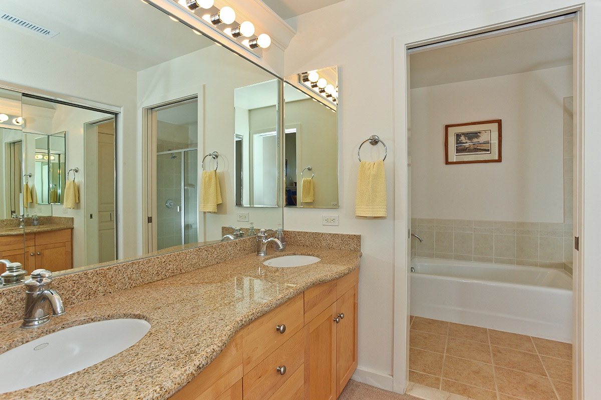 Kapolei Vacation Rentals, Kai Lani 12D - The primary guest bathroom features a double vanity, shower and bathtub.