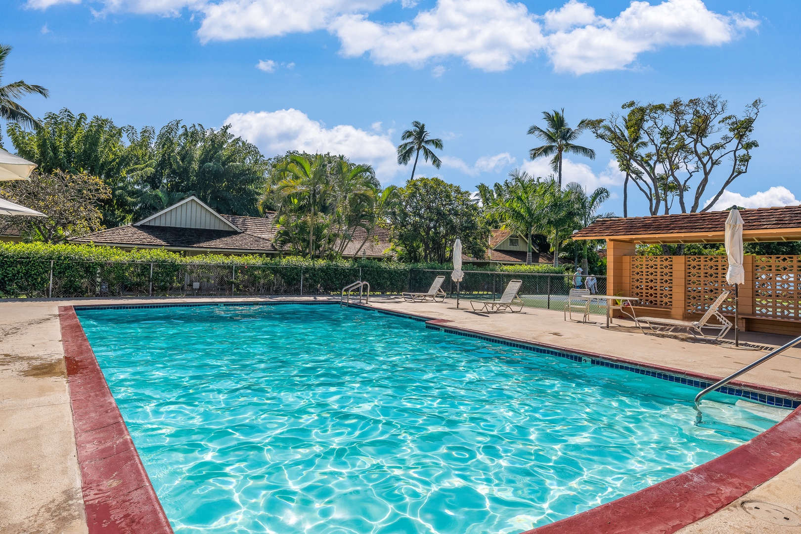 Lahaina Vacation Rentals, Puamana 254-2 - Puamana Resort's dolphin pool offers ample lounge chairs for a relaxing day under the sun.