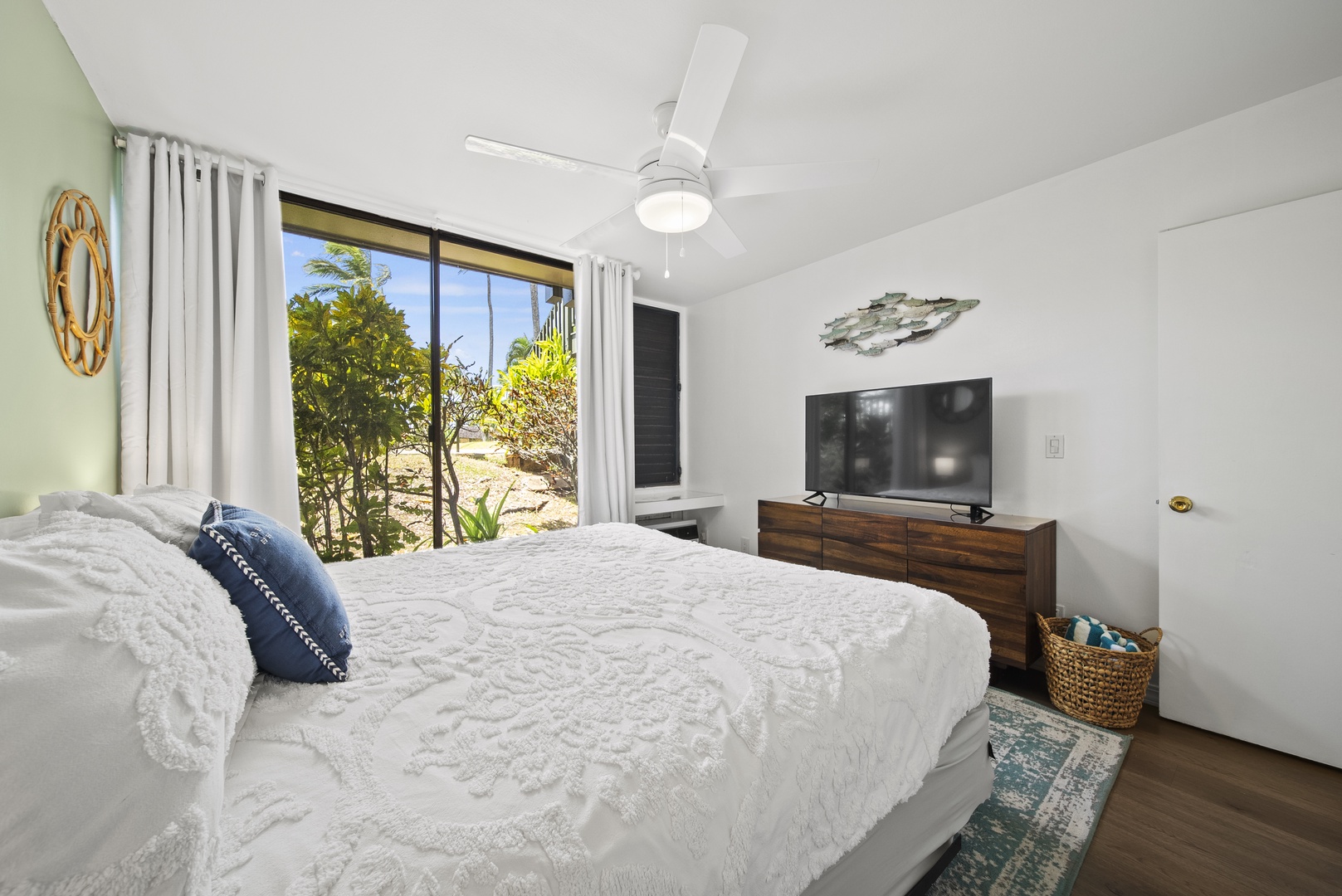 Kahuku Vacation Rentals, Pulelehua Kuilima Estates West #142 - The bedroom offers smart TV, privacy curtains, and air conditioning for a comfortable night’s rest.