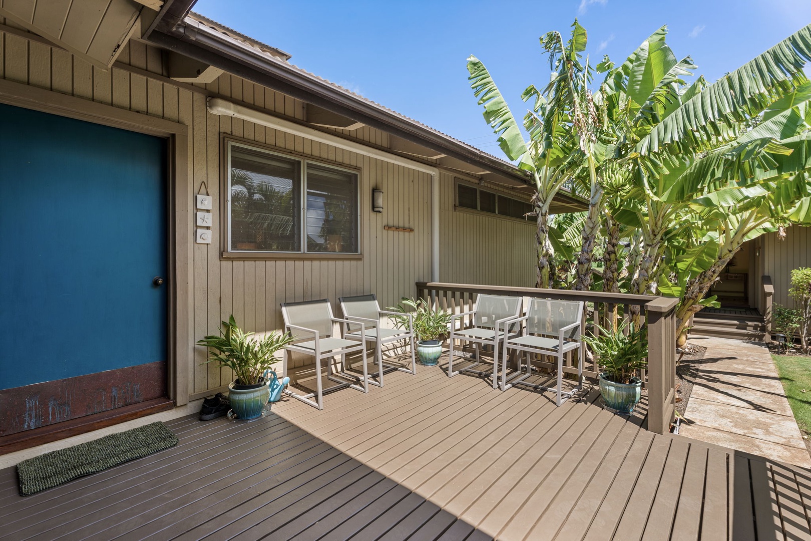 Kamuela Vacation Rentals, Island Time Retreat - The blue door and a couple of chairs mark the way in, framed by tropical plants.