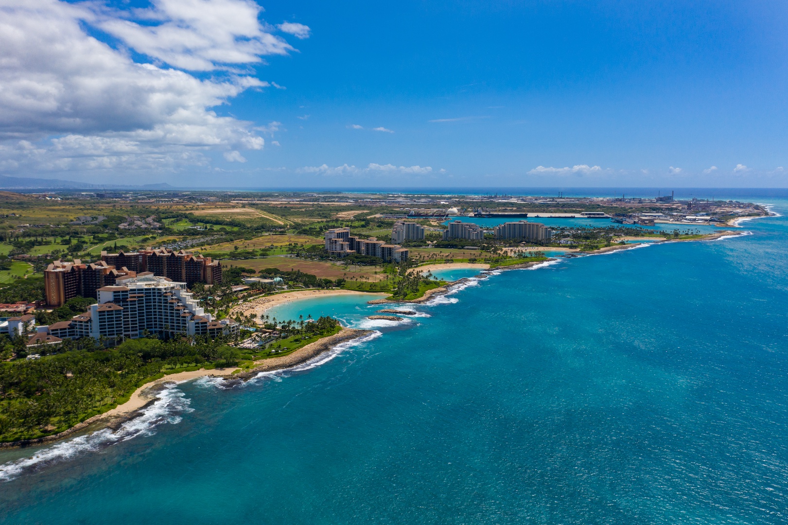 Turquoise shallows along the leeward coast, the resort tucked in past the point.
