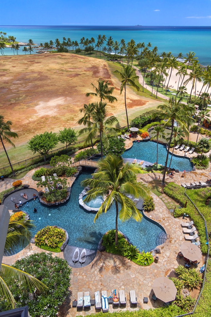 Kapolei Vacation Rentals, Ko Olina Beach Villas B901 - Stunning aerial view showcases the resort's lagoon-style pool surrounded by swaying palms, with pristine beach and turquoise ocean beyond.