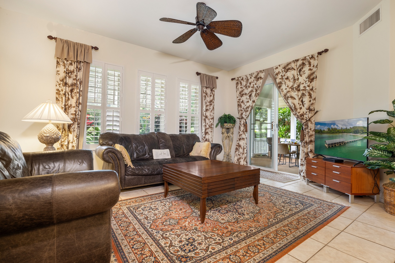 Kapolei Vacation Rentals, Coconut Plantation 1150-2 - Relax in your elegant living room with plush leather seating, ceiling fan, and doors opening to your private outdoor space.