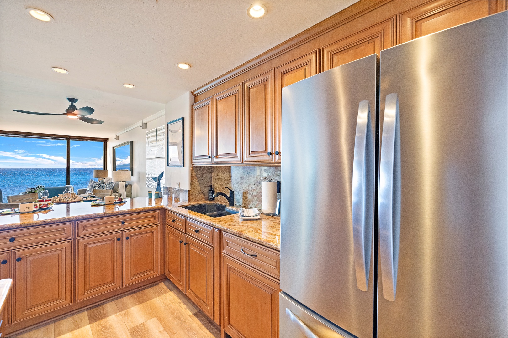 Lahaina Vacation Rentals, Mahana 1118 - The spacious kitchen offers plenty of counter space and is equipped with stainless steel appliances, perfect for preparing meals and enjoying a relaxed dining experience.