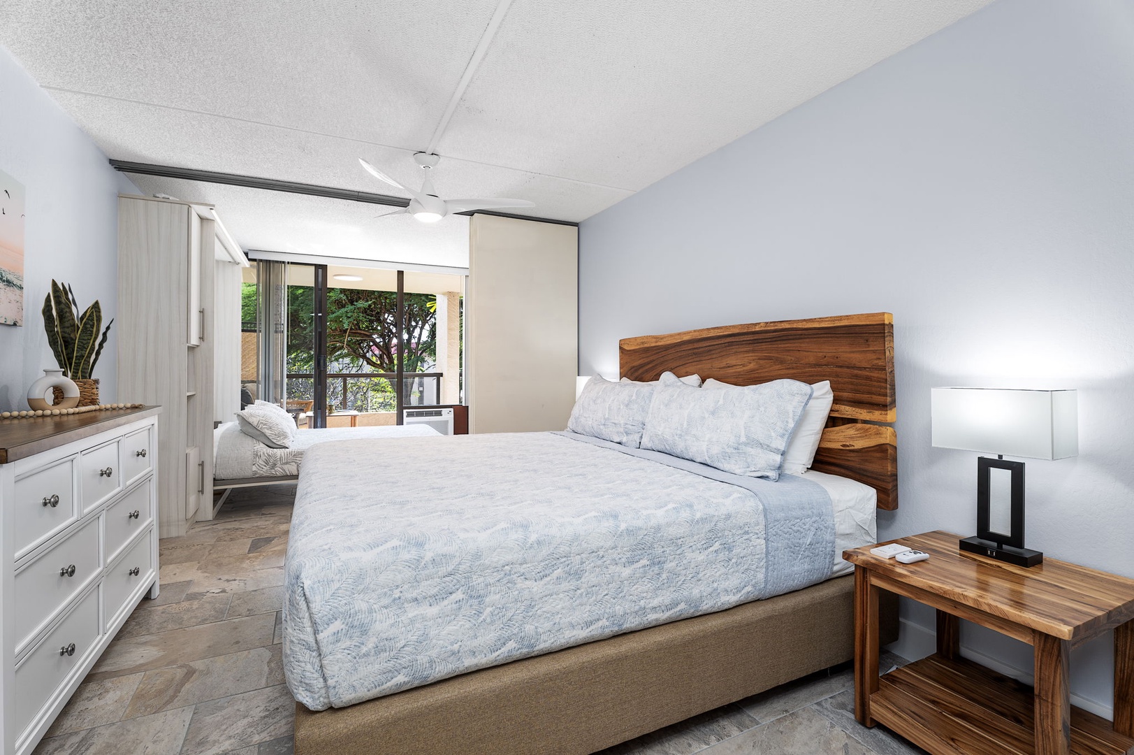 Kailua Kona Vacation Rentals, Kona Pacific C416 - Primary bedroom with a plush King bed and serene decor. (doors to bonus room open)