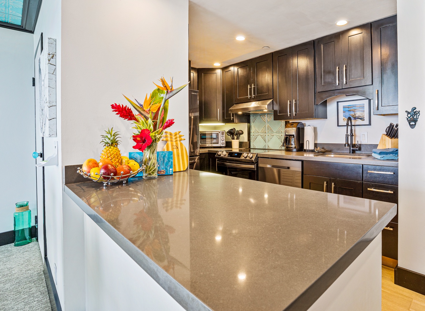 Lahaina Vacation Rentals, Valley Isle 804 - The sleek kitchen island offers ample counter space, perfect for enjoying a casual breakfast with vibrant island decor enhancing the ambiance.