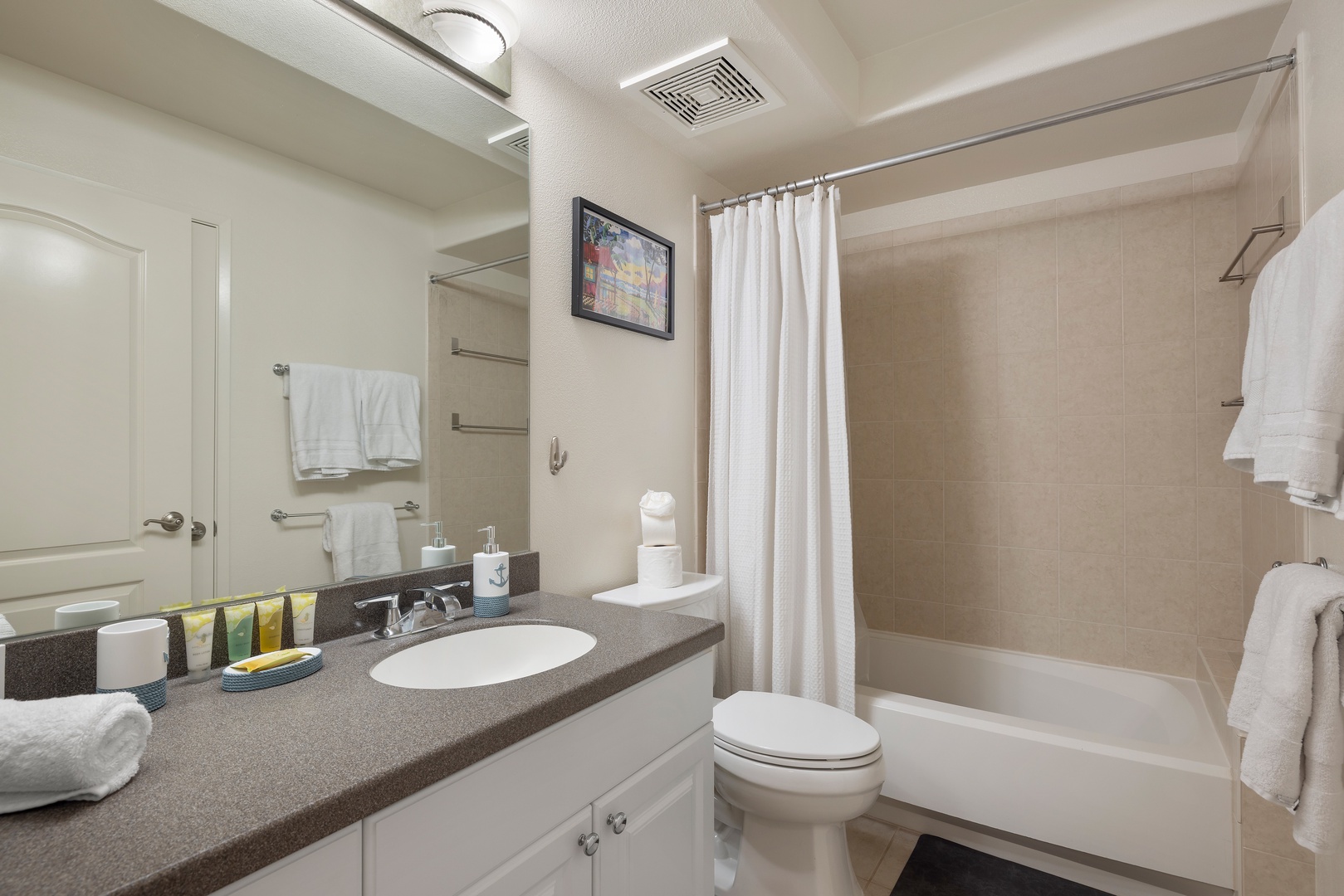Kapolei Vacation Rentals, Ko Olina Kai 1061F - Well-appointed bathroom with vanity storage and a shower-tub combo.