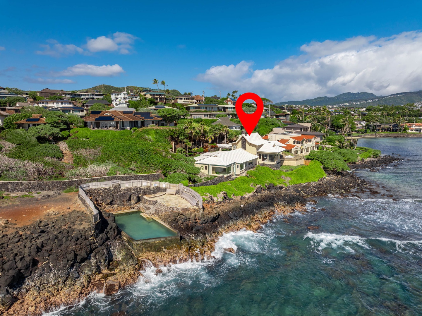 Honolulu Vacation Rentals, Black Point Ocean Villa - Nestled in lush tropical landscape with mountain backdrop and pristine coastline.