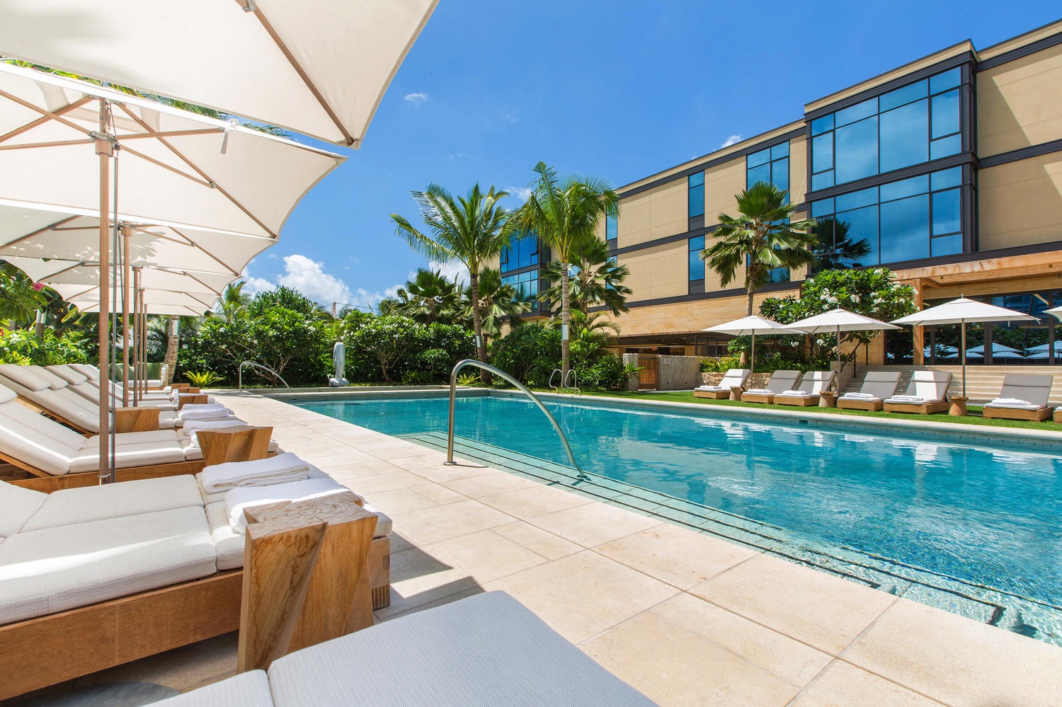 Honolulu Vacation Rentals, Park Lane Sunset Resort - Relax poolside under tropical palms with plush loungers and shaded umbrellas—your perfect sunny escape awaits.